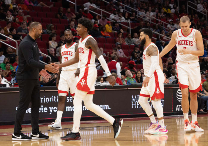 Rockets head coach Ime Udoka low fives Houston Rockets guard Jalen Green after the Miami Heat called timeout.